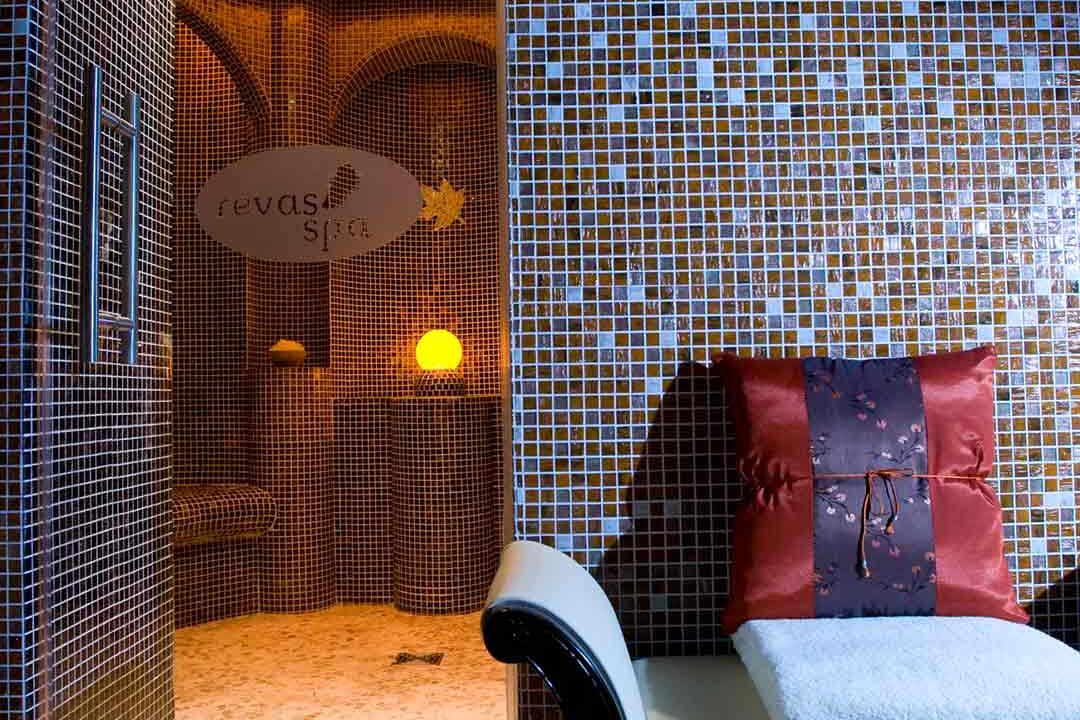 Luxurious spa interior with starry ceiling, plush seating, tiled walls, and warm lighting, promising ultimate relaxation.