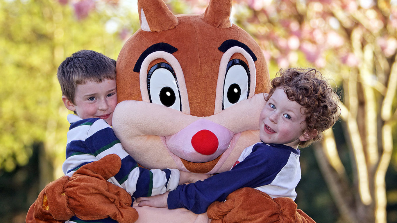 Kids hugging Woody from Woody's Kids Club