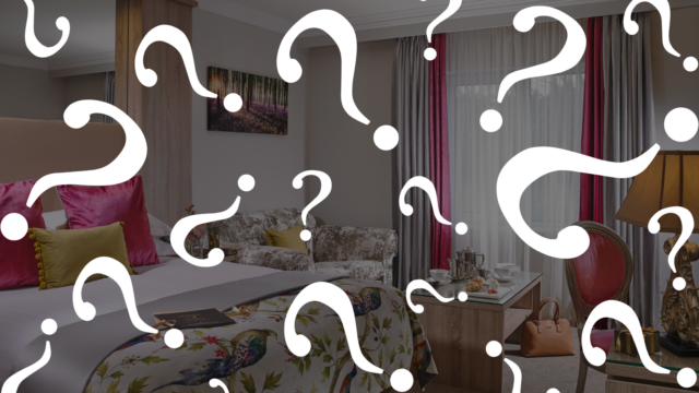 Elegant hotel room with plush bed, stylish d&eacute;cor, and cosy seating area, perfect for a relaxing stay and city views.