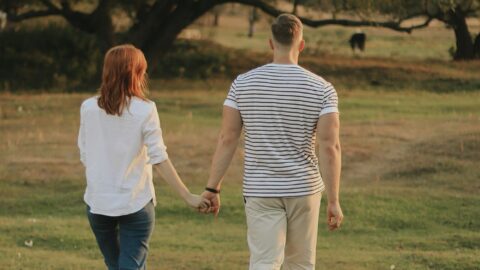 Couples walking hand-in-hand through our serene hotel gardens, surrounded by lush greenery and tranquil nature.