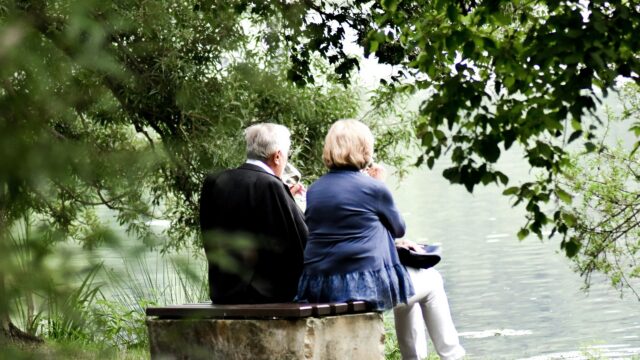 Guests enjoying serene lake views amongst lush greenery, ideal for relaxing getaways and nature lovers.